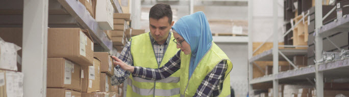 woman with headscarf working in warehouse