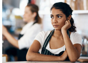female coffeeshop worker thinking