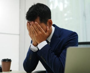 businessman with face in his palms